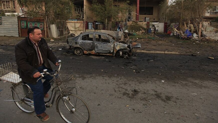 A man on his bicycle passes near the site of a car bomb attack in Baghdad, January 14, 2014. Four car bombs killed at least 25 people in Shi'ite Muslim districts of Baghdad on Monday, police said, in violence that coincided with a visit to the Iraqi capital by U.N. Secretary-General Ban Ki-moon. Although no group claimed responsibility, the bombings appeared to be part of a relentless campaign by al Qaeda-linked Sunni Muslim militants to undermine Prime Minister Nuri al-Maliki's Shi'ite-led government. REUT