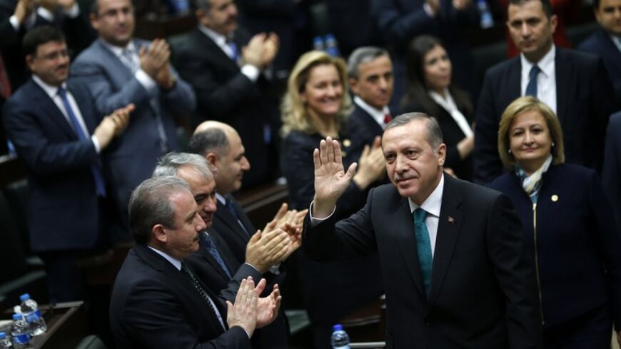 Turkey's Prime Minister Tayyip Erdogan greets his supporters as he arrives for a meeting at the parliament in Ankara January 14, 2014. Erdogan looks to have the upper hand in a civil war rocking Turkey's political establishment, but his bid to break the influence of a potent Islamic cleric could roll back reforms and undermine hard-won business confidence. What erupted a month ago as a damaging inquiry into alleged government corruption has spiralled into a battle over the judiciary with potentially much fu