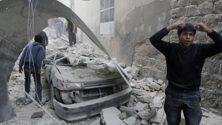A man that survived shelling reacts amid damage after what activists said was an air strike by forces loyal to Syria's president Bashar Al-Assad in the Al-Maysar neighborhood of Aleppo January 19, 2014. REUTERS/Saad Abobrahim (SYRIA - Tags: POLITICS CIVIL UNREST CONFLICT) - RTX17LJ6