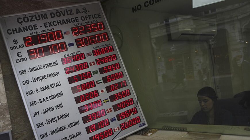 Foreign exchange rates are displayed on a screen outside of an exchange office in central Istanbul January 29, 2014. Turkish Finance Minister Mehmet Simsek played down the impact on growth of a sharp hike in interest rates on Wednesday, saying the economy would have suffered greater damage from a loss of faith in the central bank. The bank raised all its key interest rates in dramatic fashion at an emergency policy meeting late on Tuesday, ignoring opposition from Prime Minister Tayyip Erdogan as it battles
