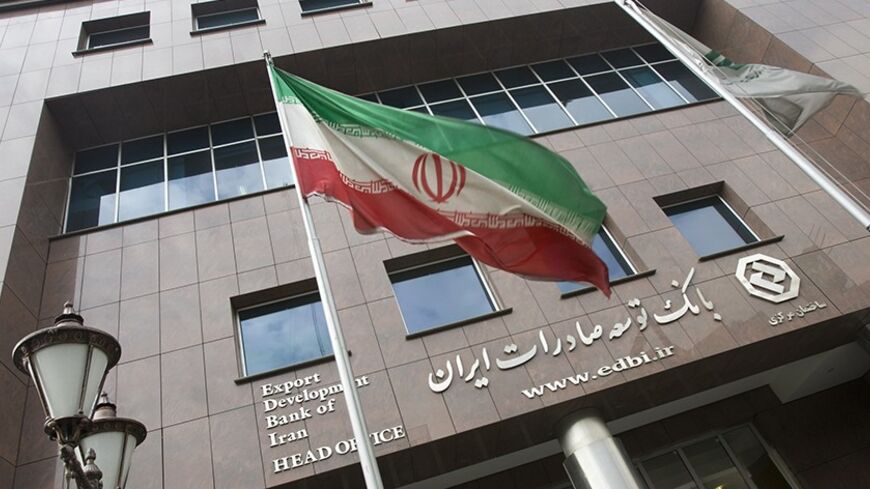 An Iranian flag flutters in front of the head office of the Export Development Bank of Iran (EDBI) in Tehran November 9, 2008. REUTERS/Morteza Nikoubazl (IRAN) - RTXAEWW