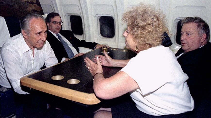 Acting Israeli Prime Minister Shimon Peres (L), listens to his cabinet minister Shulamit Aloni (R), and with Minister Avraham Shohat (R), and senior adviser Uri Savir - RTXFKKT