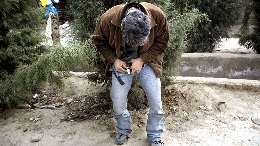 An Iranian drug addict injects himself with heroin near the Zeytoun (olive) drug rehabilitation center in south Tehran February 23, 2004. The Zeytoun center is run by a former addict called 'Forouhar' who weaned himself off drugs in the [United States]. Senior police officers have recently estimated that the Islamic Republic has some two million addicts and their forces struggle to contend with huge consignments of drugs smuggled over the porous border with [Afghanistan].   
? OUT 
? ONLINES - RTXMFZA