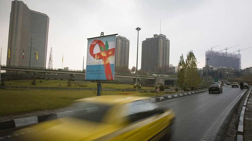 EDITORS' NOTE: Reuters and other foreign media are subject to Iranian restrictions on their ability to report, film or take pictures in Tehran.

A banner with the image of a red ribbon hangs on the side of a highway in Tehran December 1, 2009. The banner reads: ""Having access to training, prevention and treatment of AIDS is the right of all people." REUTERS/Morteza Nikoubazl (IRAN HEALTH SOCIETY) - RTXRBP6