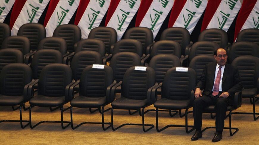 Iraq's Prime Minister Nuri al-Maliki waits to take an oath at the house of parliament in Baghdad December 21, 2010. Iraq's parliament approved Nuri al-Maliki as prime minister on Tuesday, giving the Shi'ite leader a second term as Iraq tries to cement fragile security gains and build its fledging democracy.  REUTERS/Saad Shalash (IRAQ - Tags: POLITICS IMAGES OF THE DAY) - RTXVXLT