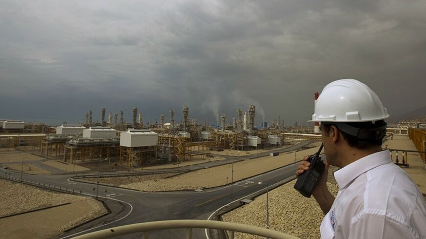 EDITORS' NOTE:  Reuters and other foreign media are subject to Iranian restrictions on their ability to film or take pictures in Tehran. 

An engineer speaks on his radio at the Phase 4 and Phase 5 gas refineries in Assalouyeh, 1,000 km (621 miles) south of Tehran, January 27, 2011.  REUTERS/Caren Firouz (IRAN - Tags: ENERGY BUSINESS) - RTXX5WC