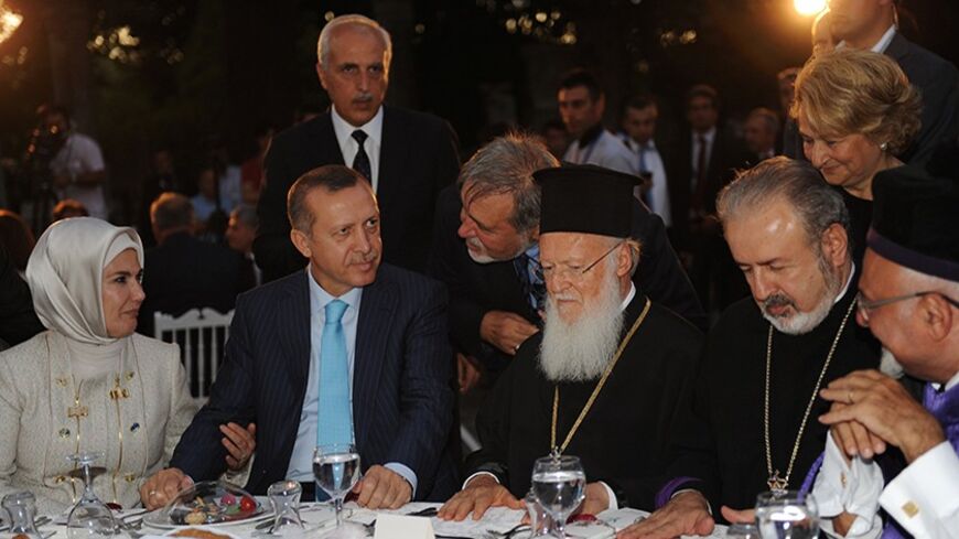 Turkish Prime Minister Recep Tayyib Erdogan`s wife Emine Erdogan (L), Recep Tayyip Erdogan (2nd L), Ecumenical Patriarch Bartholomew (C), Armenian Orthodox Archbishop Aram Atesyan (2nd R), and Chief Rabbi Ishak Haleva (R) take their places during a dinner on August 28, 2011, at the Archeology Museum Garden in Istanbul. Erdogan hosted religious leaders and the heads of about 160 minority trusts at a fast-breaking dinner for Ramadan. AFP PHOTO/BULENT KILIC (Photo credit should read BULENT KILIC/AFP/Getty Imag