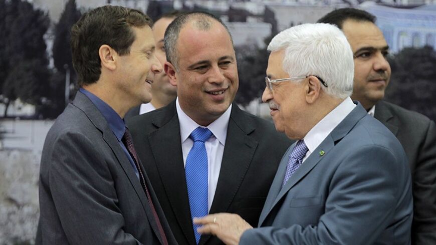 Israeli MP Labour Party members Isaac Herzog (L) and Hilik Bar (C) shake hands with Palestinian Authority President Mahmoud Abbas as they attend a meeting with Knesset members (Israel's Parliament) in the West Bank city of Ramallah on October 7, 2013. The Palestinians must "recognise Israel as the state of the Jewish people" in order to achieve real peace, Israeli Prime Minister Benjamin Netanyahu said on October 6, 2013. AFP PHOTO/ABBAS MOMANI        (Photo credit should read ABBAS MOMANI/AFP/Getty Images)
