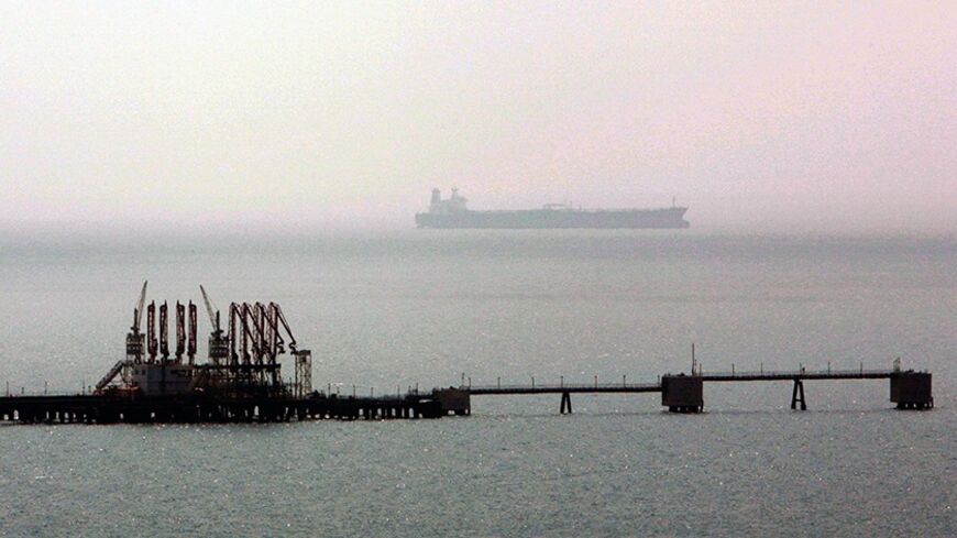 A tanker sails in Mediterranean past a jetty at the Ceyhan crude oil terminal near Turkey's southern coastal city of Adana, July 13, 2006. A four-billion dollar project, Baku-Tblisi-Ceyhan crude oil pipeline, to carry oil from the Caspian Sea fields to western markets is inaugurated on Thursday in Ceyhan, southern Turkey.  REUTERS/Fatih Saribas  (TURKEY) - RTR1FGD4