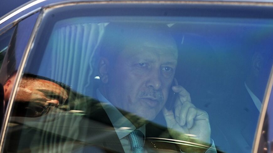 Turkey's Prime Minister Tayyip Erdogan speaks on the phone in his car during his visit to Skopje September 29, 2011. Turkey's Prime Minister Erdogan is on a two-day official visit to Macedonia.   REUTERS/Ognen Teofilovski (MACEDONIA - Tags: POLITICS) - RTR2RZV9