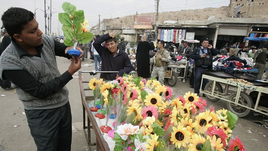 A boy sells plastic flowers at a market in central Kirkuk, 250 km (155 miles) north of Baghdad November 5, 2011. In Iraq's northern oil city Kirkuk, home to a volatile mix of Kurds, Arabs and Turkmen, politicians and residents fear a possible explosion of ethnic conflict when American troops leave. With prospects that U.S. forces will leave Iraq by Dec. 31, the city turns uncertainly to Iraqi and Kurdish security forces to keep the peace in an area contested by Iraq's central government and semi-autonomous 