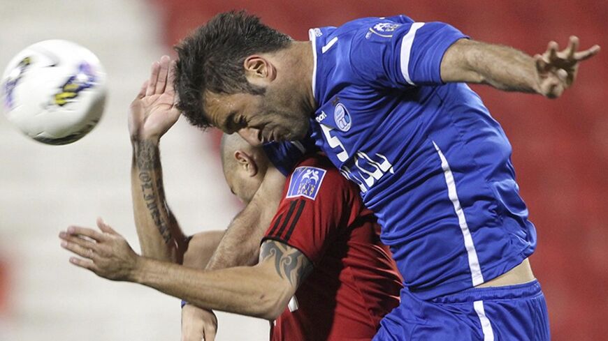 Qatar's Al-Rayyan player Afonso Alves Martins fights for the ball with Iran's Al-Esteghlal player Soheil Omran Zadeh (R) during their AFC Champions League soccer match at the Al-Rayyan Stadium in Doha March 6, 2012. REUTERS/Stringer  (QATAR - Tags: SPORT SOCCER TPX IMAGES OF THE DAY) - RTR2YXIZ