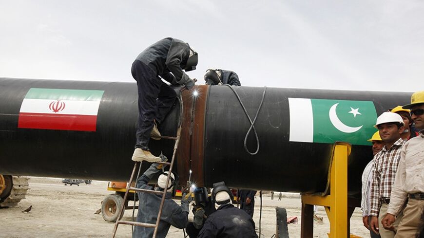 Irani workers weld the pipeline during a groundbreaking ceremony to mark the inauguration of the Iran-Pakistan gas pipeline, in the city of Chahbahar in southeastern Iran March 11, 2013. Ahmadinejad and Zardari marked the start of Pakistani construction on the much-delayed gas pipeline on Monday, Iranian media reported, despite U.S. pressure on Islamabad to back out of the project. REUTERS/Mian Khursheed  (IRAN - Tags: POLITICS ENERGY BUSINESS) - RTR3EUST