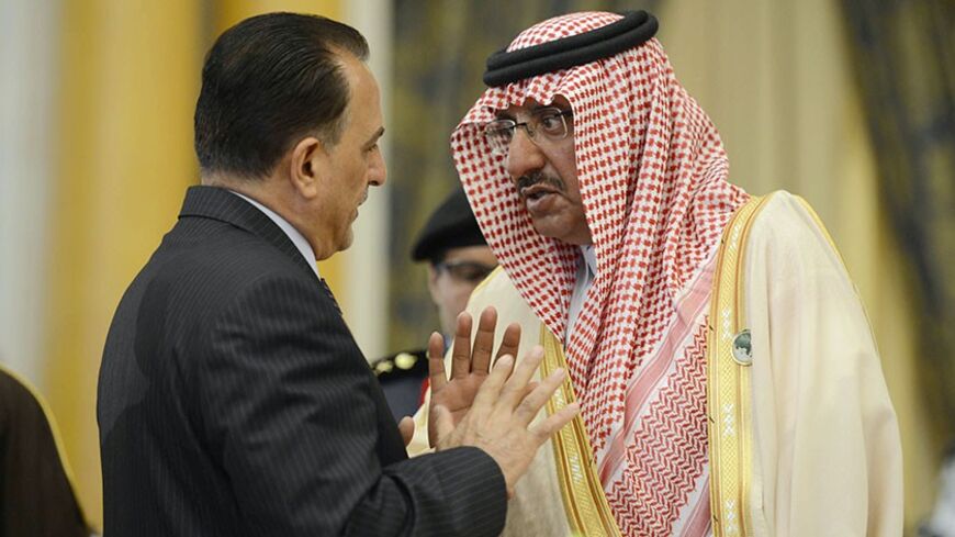 Saudi Arabia's Interior Minister Mohammed bin Nayef (R) speaks to his Iraqi counterpart Adnan al-Asadi during the conference of Arab Interior Ministers in Riyadh March 13, 2013. Interior ministers of the 22-nation Arab League met in the Saudi capital on Wednesday. REUTERS/Stringer (SAUDI ARABIA - Tags: POLITICS) - RTR3EX57