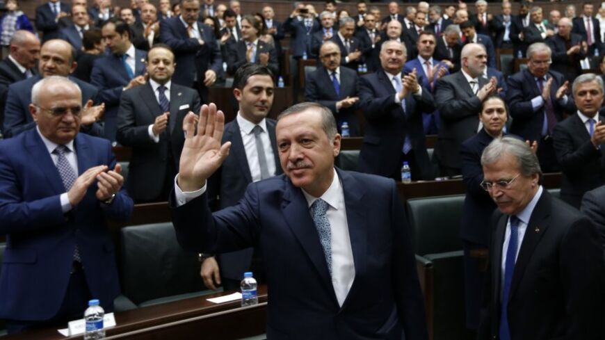 Turkey's Prime Minister Tayyip Erdogan greets his supporters as he arrives for a meeting at the Turkish parliament in Ankara February 25, 2014.   Erdogan said on Tuesday voice recordings purportedly of him telling his son to dispose of large sums of money on the day news broke of a graft inquiry were a "treacherous attack" on his office.  REUTERS/Umit Bektas (TURKEY - Tags: POLITICS BUSINESS TPX IMAGES OF THE DAY) - RTR3FP9H
