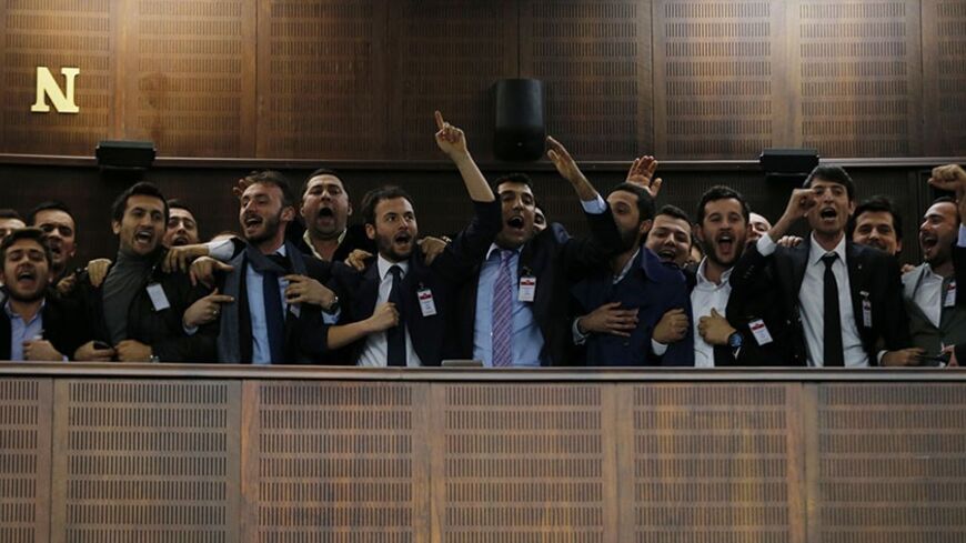 Supporters of Turkey's Prime Minister Tayyip Erdogan react as he addresses the audience during a meeting at the Turkish parliament in Ankara February 25, 2014. Erdogan said on Tuesday voice recordings purportedly of him telling his son to dispose of large sums of money on the day news broke of a graft inquiry were a "treacherous attack" on his office. In a speech to his ruling AK Party deputies in parliament, Erdogan also said the recordings, which appeared on YouTube late on Monday, were a "shameless monta