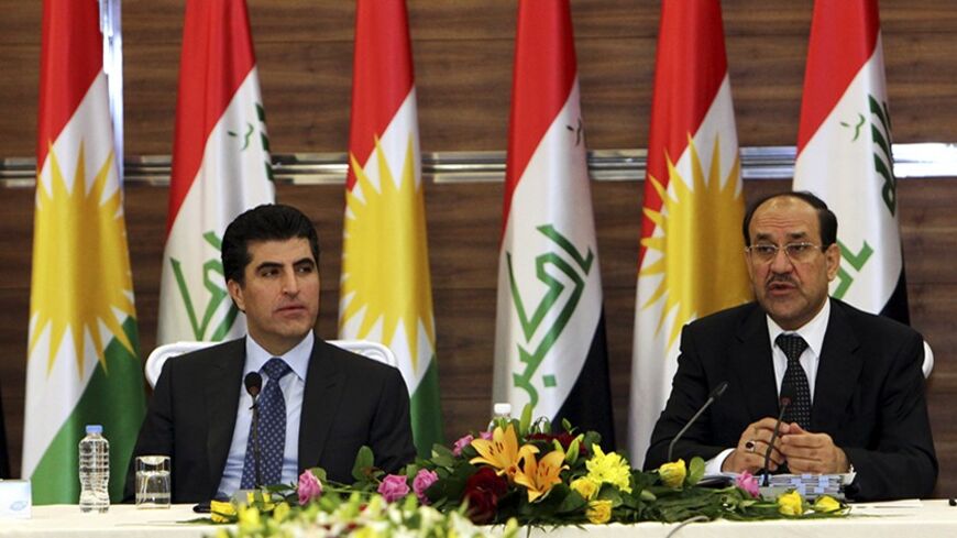 Iraqi Prime Minister Nuri al-Maliki (R) speaks next to his Iraqi Kurdish counterpart Nechirvan Barzani during a meeting of the Council of Ministers in Arbil, about 350 km (220 miles) north of Baghdad June 9, 2013. Maliki visited the Kurdistan region on Sunday for the first time in more than two years, in an attempt to resolve a long-running dispute over oil and land that has strained Iraq's unity to the limit. REUTERS/Azad Lashkari (IRAQ - Tags: POLITICS) - RTX10H5T
