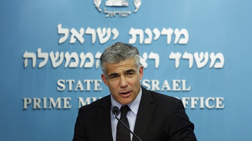 Israel's Finance Minister Yair Lapid speaks during a joint news conference with Prime Minister Benjamin Netanyahu, Bank of Israel Governor Stanley Fischer, Energy Minister Silvan Shalom and  (not pirctured) in Jerusalem June 19, 2013. Israel said on Wednesday it will keep the majority of it's newfound natural gas for domestic use, but will still allow enough gas to be sold abroad to satisfy exploration companies who want access to the global market. REUTERS/Baz Ratner (JERUSALEM - Tags: POLITICS ENERGY BUSI