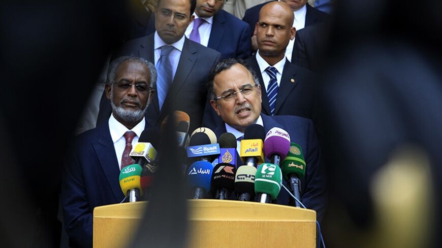Sudan's Foreign Minister Ali Karti (L) and his Egyptian counterpart Nabil Fahmy hold a joint news conference in Khartoum August 19, 2013. REUTERS/ Mohamed Nureldin Abdallah (SUDAN - Tags: POLITICS) - RTX12QUS