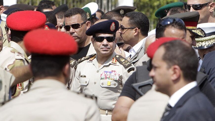 Army Chief General Abdel Fattah al-Sisi (C) attends the military funeral service of Police General Nabil Farag, who was killed on Thursday in Kerdasa, at Al-Rashdan Mosque in Cairo's Nasr City district September 20, 2013. Egyptian security forces were hunting for supporters of deposed President Mohamed Mursi of the Muslim Brotherhood on Friday after retaking control of a town near Cairo in a crackdown on Islamists. On Thursday, army and police forces stormed Kerdasa where Islamist sympathies run deep and ho