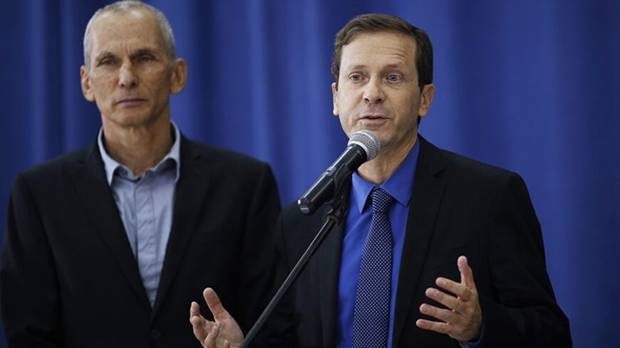 Isaac Herzog (R), the newly elected head of Israel's left-of-centre Labour Party, speaks during a news conference after his meeting with Palestinian President Mahmoud Abbas in the West Bank city of Ramallah December 1, 2013. REUTERS/Mohamad Torokman (WEST BANK - Tags: POLITICS) - RTX15ZO7