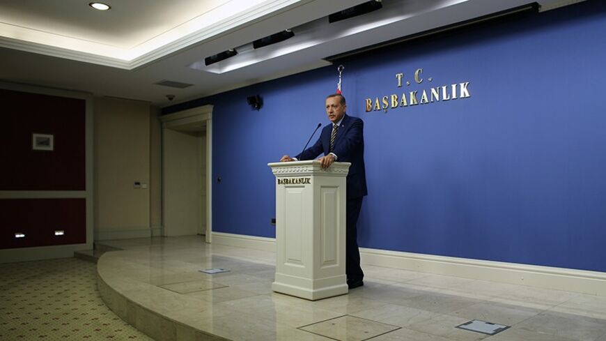 Turkey's Prime Minister Tayyip Erdogan addresses the media in Ankara December 25, 2013. Erdogan said he replaced ten cabinet ministers, half of his total roster, after three ministers resigned over a high-level graft inquiry on Wednesday. The replaced ministers included EU Minister Egemen Bagis, who was allegedly named in the corruption probe but had not resigned yet, and key positions such as the Economy and justice ministers. REUTERS/Umit Bektas (TURKEY - Tags: POLITICS CRIME LAW) - RTX16TYO