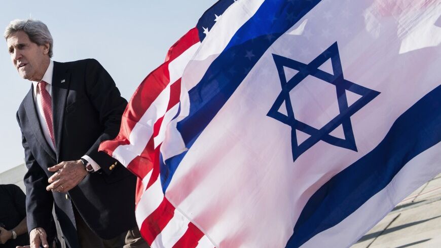 U.S. Secretary of State John Kerry walks past American (back) and Israeli flags at Ben Gurion International Airport in Tel Aviv January 6, 2014.  REUTERS/Brendan Smialowski/Pool (ISRAEL - Tags: POLITICS) - RTX173RK