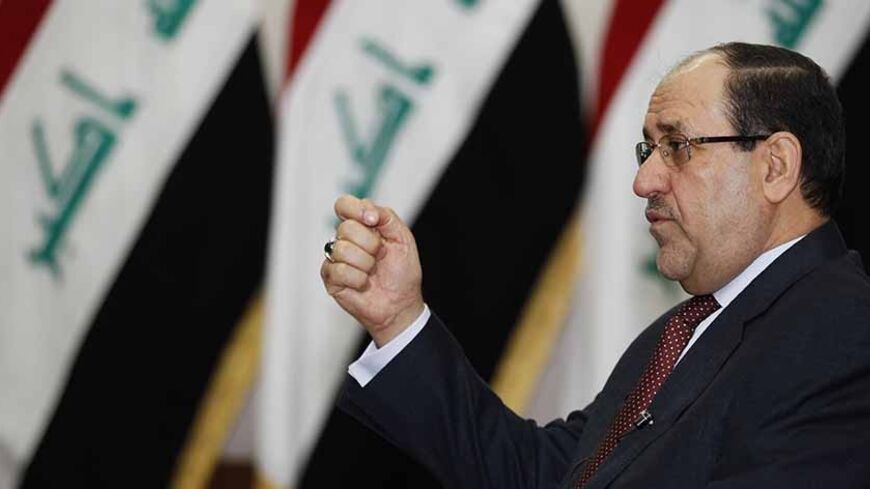 Iraq's Prime Minister Nuri al-Maliki speaks during an interview with Reuters in Baghdad January 12, 2014. Iraqi Prime Minister Nuri al-Maliki threatened on Sunday to cut central government funding for Iraq's autonomous Kurdistan region if the Kurds pursued a drive to pipe oil exports to Turkey without Baghdad's approval. The Kurdistan Regional Government said last week that crude had begun to flow to Turkey and exports were expected to start at the end of this month and then rise in February and March.    T