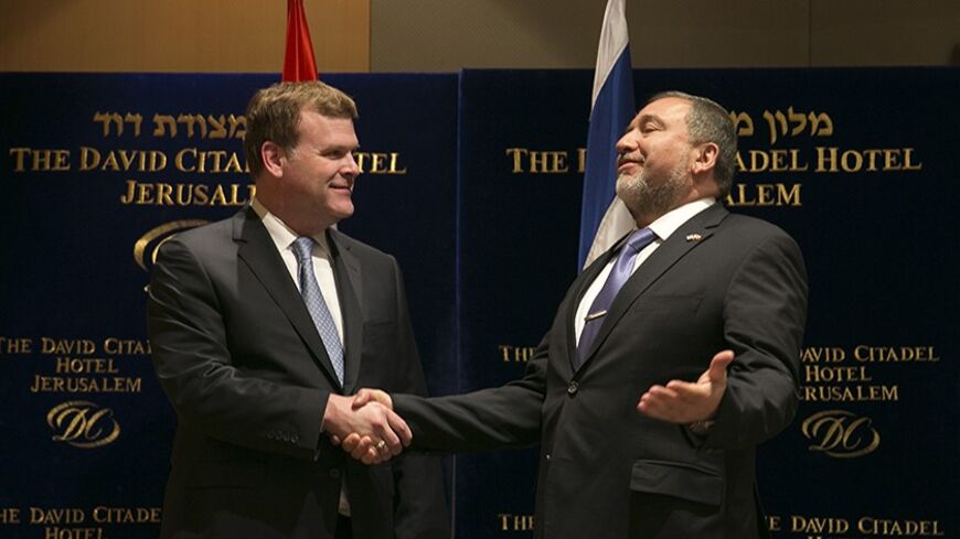 Israel's Foreign Minister Avigdor Lieberman (R) greets his Canadian counterpart John Baird before their dinner in Jerusalem January 19, 2013. Canadian Prime Minister Stephen Harper is on a four-day visit to Israel and the Palestinian Territories. REUTERS/Darren Whiteside (JERUSALEM - Tags: POLITICS) - RTX17LHJ