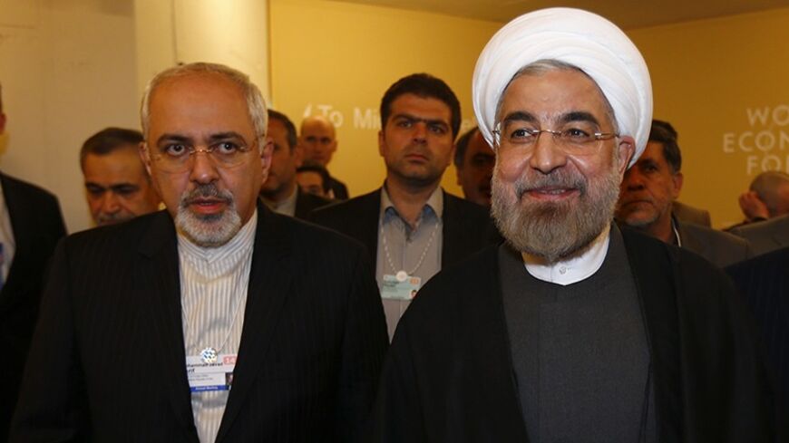 Iran's President Hassan Rouhani (R) and Iran's Foreign Minister Mohammad Javad Zarif arrive for a meeting during the annual meeting of the World Economic Forum (WEF) in Davos January 22, 2014.                 REUTERS/Denis Balibouse (SWITZERLAND  - Tags: POLITICS BUSINESS)   - RTX17PYK