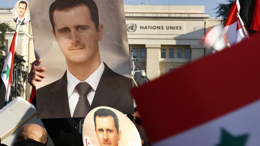 Supporters of Syrian President Bashar al-Assad carry Syrian flags and portraits in front of the United Nations European headquarters in Geneva January 31, 2014.  REUTERS/Denis Balibouse (SWITZERLAND - Tags: POLITICS CIVIL UNREST) - RTX181ZH