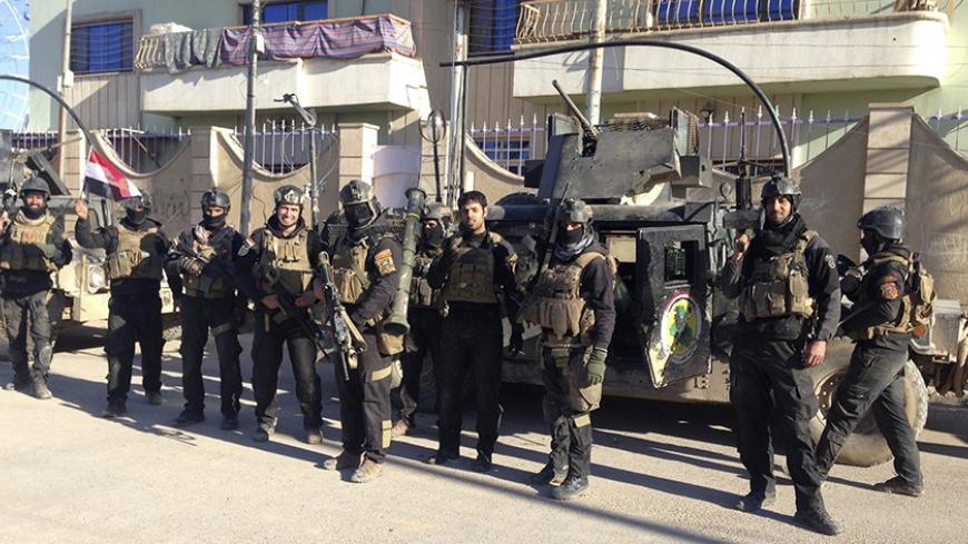 Iraqi SWAT troopers pose for pictures as they take part in an intensive security deployment during clashes with al Qaeda-linked Islamic State in Iraq and the Levant (ISIL) in the city of Ramadi, 100 km (62 miles) west of Baghdad, February 1, 2014.  Iraqi troops and allied tribesmen killed 57 Islamist militants in Anbar province on Monday, the Defence Ministry said, in advance of a possible assault on the Sunni rebel-held city of Falluja. There was no independent verification of the toll among the militants,