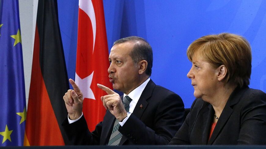 German Chancellor Angela Merkel and Turkey's Prime Minister Tayyip Erdogan address the media after talks in Berlin February 4, 2014. REUTERS/Tobias Schwarz  (GERMANY - Tags: POLITICS) - RTX187HH