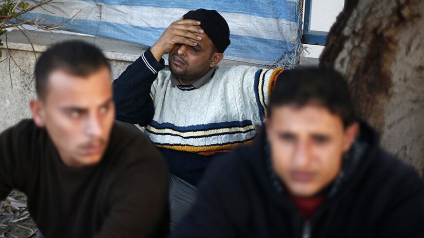 Palestinian relatives of Ibrahim Mansour, 26, who was killed by Israeli soldiers, react outside a hospital morgue in Gaza City February 13, 2014. Israeli soldiers shot and killed a Palestinian and wounded another on Thursday in the Gaza Strip, local hospital officials said. Relatives who rushed to a Gaza City hospital said Mansour was collecting gravel to sell from his donkey cart when he was shot dead. The Israeli military said soldiers fired at Palestinians tampering with Israel's border security fence. R
