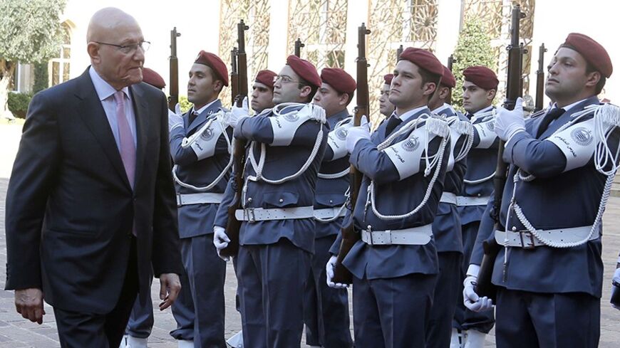 Lebanon's Prime Minister Tammam Salam reviews an honour guard during an official ceremony at the governmental palace to mark his assumption of duties as the new premier February 17, 2014. Lebanon announced a new government on Saturday, breaking a 10-month political deadlock during which spillover violence from neighbouring Syria worsened internal instability. REUTERS/Mohamed Azakir   (LEBANON - Tags: POLITICS) - RTX18YZB