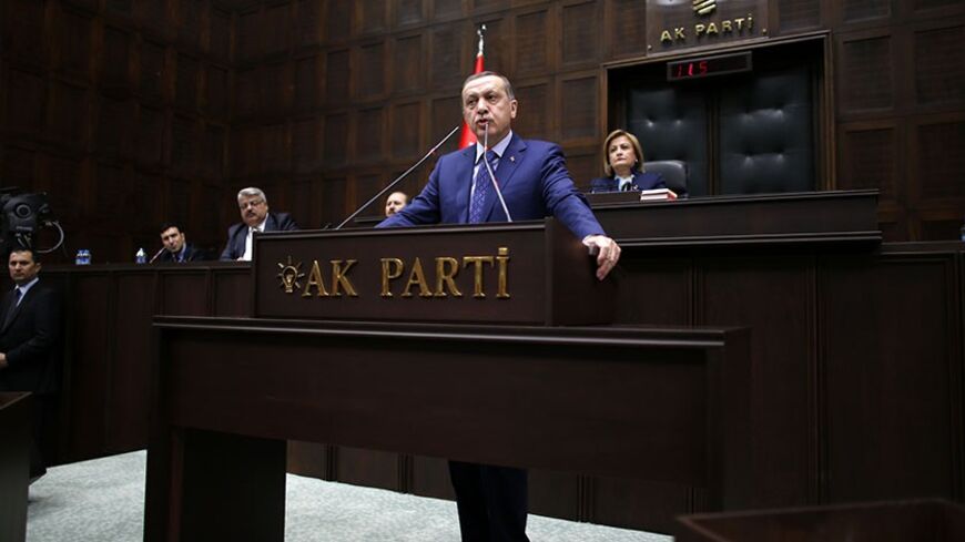 Turkey's Prime Minister Tayyip Erdogan addresses members of parliament from his ruling AK Party (AKP) during a meeting at the Turkish parliament in Ankara February 18, 2014. REUTERS/Umit Bektas (TURKEY - Tags: POLITICS TPX IMAGES OF THE DAY) - RTX1915M