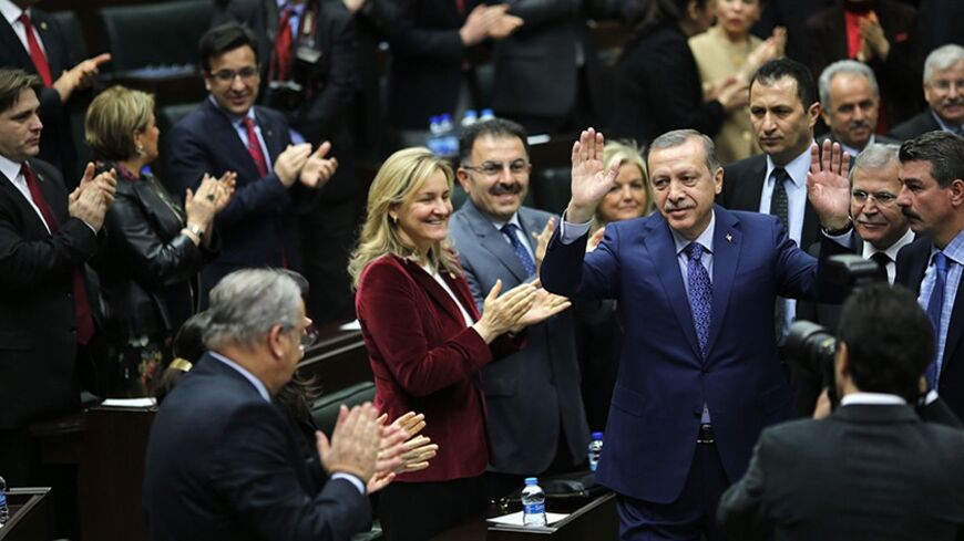 Turkey's Prime Minister Tayyip Erdogan greets his supporters as he arrives at a meeting at the Turkish parliament in Ankara February 18, 2014. REUTERS/Umit Bektas (TURKEY - Tags: POLITICS) - RTX1916P