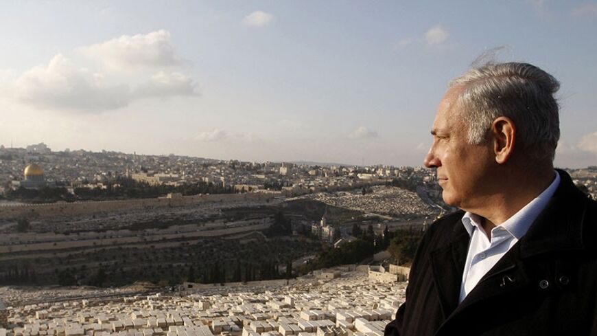 Israel's Likud Party leader Benjamin Netanyahu visits the Mount of Olives during a tour in Jerusalem February 2, 2009. Netanyahu is a candidate for prime minister in Israel's February 10 election. Opinion polls forecast victory for right-winger Netanyahu. In the background is the Dome of the Rock in the compound known to Muslims as al-Haram al-Sharif, and to Jews as Temple Mount, in Jerusalem's Old City. REUTERS/Ronen Zvulun (JERUSALEM) - RTXB5P8