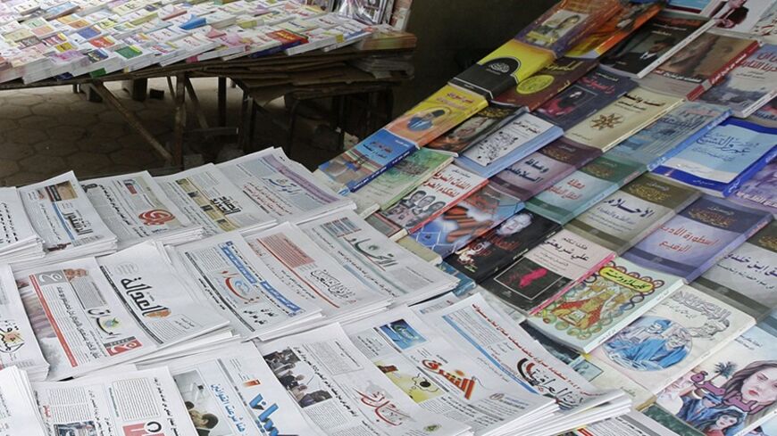 A resident buys a newspaper from a kiosk in Baghdad February 23, 2009. A boom in local media since the U.S.-led invasion in 2003 has given Iraqis a choice between some 200 print outlets, 60 radio stations and 30 TV channels in Arabic, Turkmen, Syriac and two Kurdish dialects. Yet most media outlets remain dominated by sectarian and party patrons who use them for their own ends, and have yet to become commercially sustainable enterprises let alone watchdogs keeping government under scrutiny, the favoured Wes