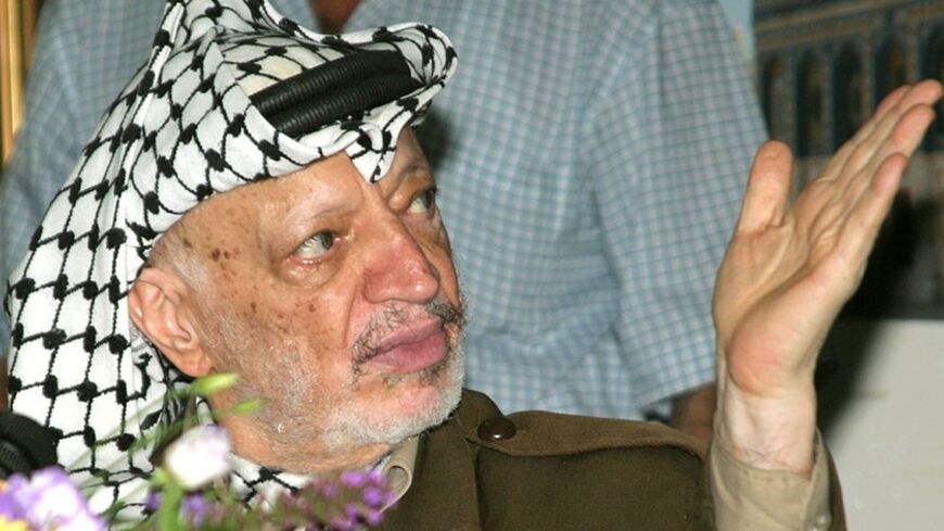 Palestinian President Yasser Arafat attends a meeting in his headquarters in the West Bank city of Ramallah July, 19, 2004. [Palestinian President Yasser Arafat sought on Monday to defuse a leadership crisis triggered by unprecedented unrest in the Gaza Strip over corruption within his government and security forces.] - RTXMS1N
