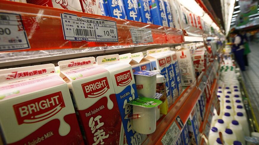 Milk produced by Bright Food is displayed for sale on shelves at a supermarket in Shanghai September 27, 2010. China's Bright Food Group is exploring the purchase of Britain's United Biscuits, a source said on Monday, a deal that at roughly $3.2 billion would be the largest ever international purchase by a Chinese company in the food and beverage sector.  REUTERS/Aly Song (CHINA - Tags: BUSINESS FOOD) - RTXSPM8