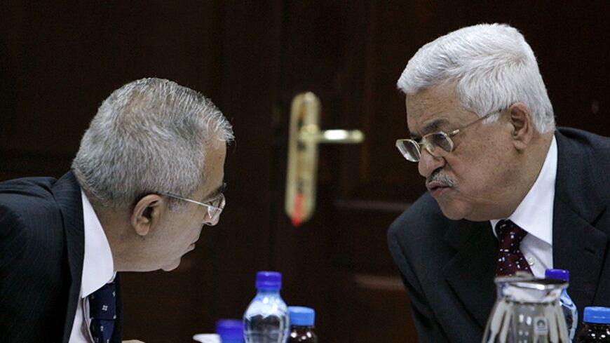 Palestinian President Mahmoud Abbas (R) and Salam Fayyad, whom Abbas named prime minister to replace Hamas's Ismail Haniyeh, attend a cabinet meeting in the West Bank city of Ramallah July 26, 2007. Abbas accepted the resignation on Thursday of his top security adviser, Mohammad Dahlan, a senior official in Abbas's office said.  REUTERS/Loay Abu Haykel (WEST BANK) - RTR1S9IX