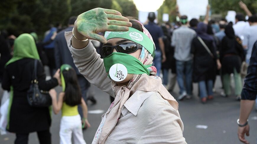 EDITORS' NOTE: Reuters and other foreign media are subject to Iranian restrictions on leaving the office to report, film or take pictures in Tehran.

A protester shows her green-painted palm in support of defeated reformist presidential candidate Mirhossein Mousavi during a silent demonstration against the results of the Iranian presidential election in central Tehran June 17, 2009. The sign across her mouth bears a stamp of Mousavi's signature. Picture taken June 17, 2009. REUTERS/Fars News (IRAN POLITICS 