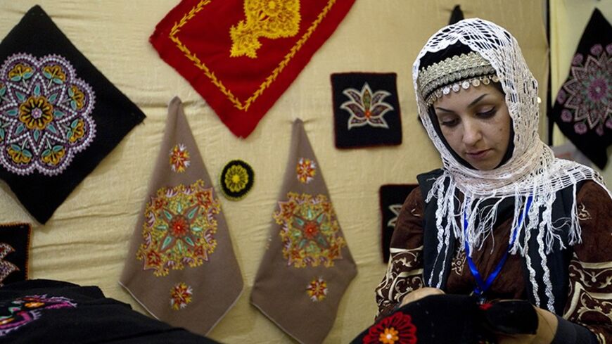 EDITORS' NOTE: Reuters and other foreign media are subject to Iranian restrictions on their ability to film or take pictures in Tehran.

A woman works on a traditional embroidery at a handicraft exhibition in Tehran June 13, 2011.  REUTERS/Caren Firouz (IRAN - Tags: SOCIETY) - RTR2NMBK