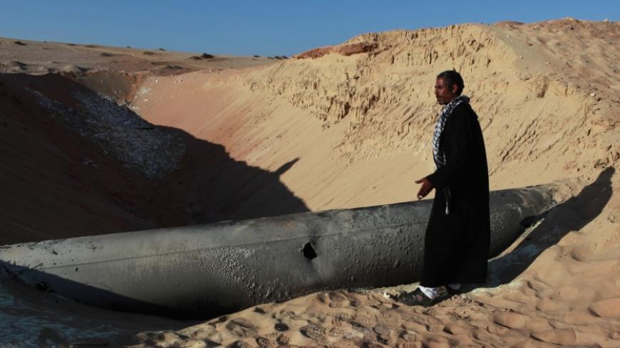 A Bedouin man looks at a gas pipeline that was hit by a RPG in North Sinai March 6, 2012. The Egyptian gas pipeline carrying gas to Israel and Jordan was attacked on Monday night, according to local Bedouin tribesmen. The pipeline has been hit by multiple attacks since President Hosni Mubarak was toppled in 2011 and remains shut since an explosion on February 5, 2011. REUTERS/Asmaa Waguih (EGYPT - Tags: CIVIL UNREST POLITICS ENERGY SOCIETY BUSINESS) - RTR2YXSZ