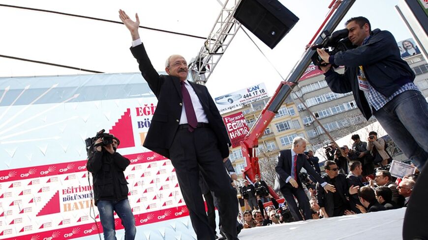 Turkey's main opposition Republican People's Party (CHP) leader Kemal Kilicdaroglu greets his supporters during a demonstration in Ankara March 27, 2012. Thousands of Turkish opposition supporters demonstrated in the capital Ankara on Tuesday against a government attempt to railroad a new education bill through parliament which secular parties say is designed to promote Islamic schooling. The government wants to overturn a 1997 law imposed with the backing of the military which led to a sharp decrease in th
