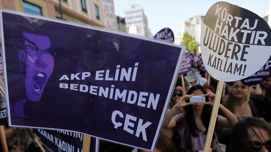 Demonstrators shout slogans as they march with placards during a protest against the government's plans on a new abortion law, in Istanbul June 17, 2012. Turkish Prime Minister Tayyip Erdogan said his government was preparing a draft bill on abortion and intended to enact it into law, a move likely to escalate a row over the practice which the Turkish leader has called "murder". Erdogan sparked outrage from women's groups, opposition lawmakers and media critics when he delivered two fiery speeches last mont