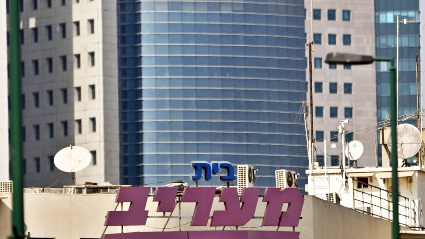 The logo of Maariv, one of Israel's largest tabloid newspapers, is seen on the newspaper's building in Tel Aviv September 9, 2012. Debt-strapped conglomerate IDB Group plans to sell Maariv for 85 million shekels ($21 million), Maariv said. REUTERS/Nir Elias (ISRAEL - Tags: BUSINESS MEDIA) - RTR37Q7Z