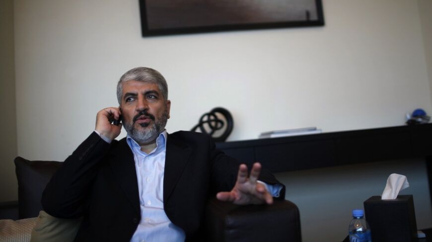 Hamas leader Khaled Meshaal uses his mobile phone in his office in Doha November 29, 2012. Meshaal said the de facto recognition of a sovereign Palestinian state won by his rival Mahmoud Abbas should be seen alongside Gaza's latest conflict with Israel as a single, bold strategy that could empower all Palestinians. Meshaal said the short war which claimed 162 Palestinian lives and five Israelis was concluded on terms set by the Palestinian Islamist movement and ended its isolation, creating a new mood that 