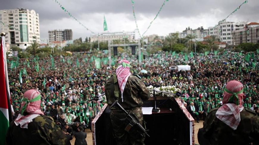 A Palestinian member of the Al-Qassam brigades, the armed wing of the Hamas movement, gives a speech during a rally marking the 25th anniversary of the founding of Hamas, in Gaza City December 8, 2012. Hamas leader Khaled Meshaal, making his first ever visit to the Gaza Strip, vowed on Saturday never to recognise Israel and said his Islamist group would never abandon its claim to all Israeli territory. REUTERS/Ahmed Jadallah (GAZA - Tags: POLITICS ANNIVERSARY CIVIL UNREST MILITARY) - RTR3BCKX